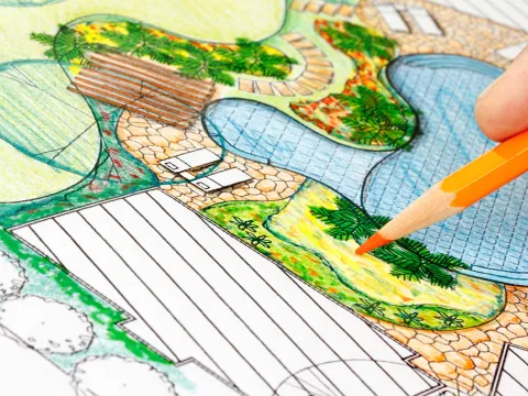 Hand mit Stift, die ein Beet plant